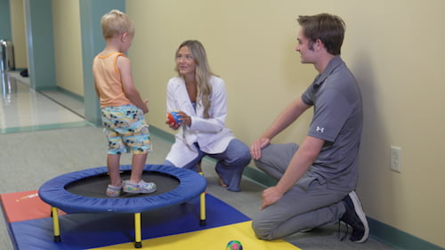 2 student assisting child