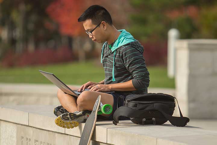 Student working on a laptop outside