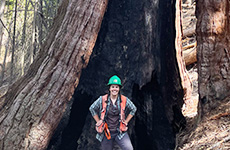 Emily Dolhansky in 2022, standing in front of a massive tree