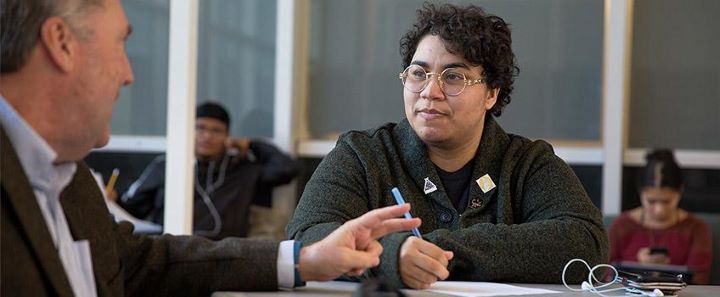 woman sitting and listening to man speak 