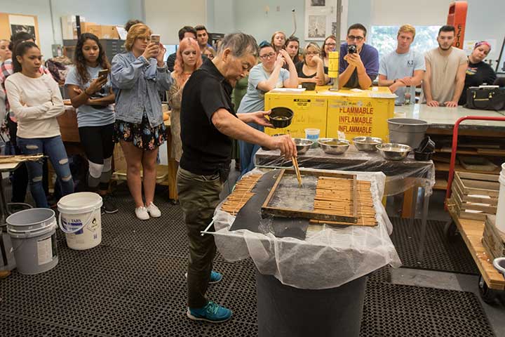 Artist demonstrates paper making