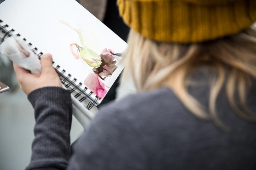 A student draws a scene from the Greenhouse