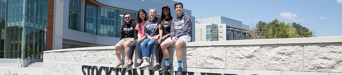 Students sitting on wall