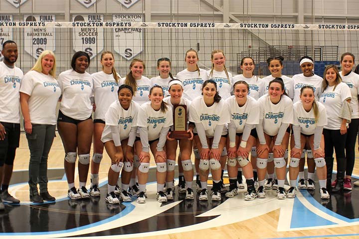 Women's volleyball team poses with NJAC trophy