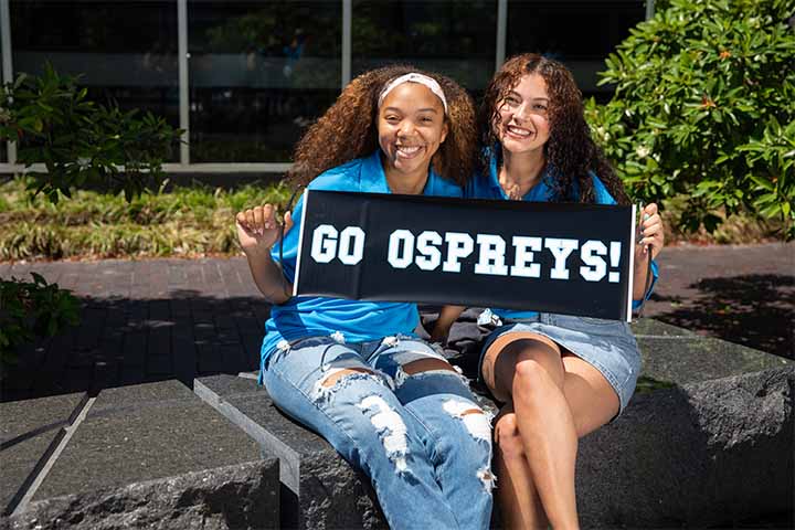 Students holding a sign that reads Go Ospreys!