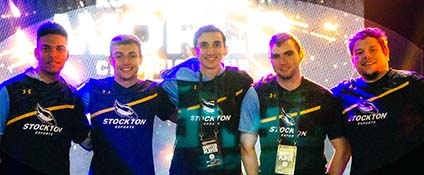 Five men wearing Stockton Esports jerseys in front of interesting lights