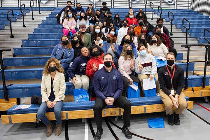 A group of students sitting in bleachers in the Sports Center