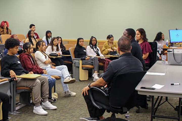 A group of students and educators in a generic classroom setting