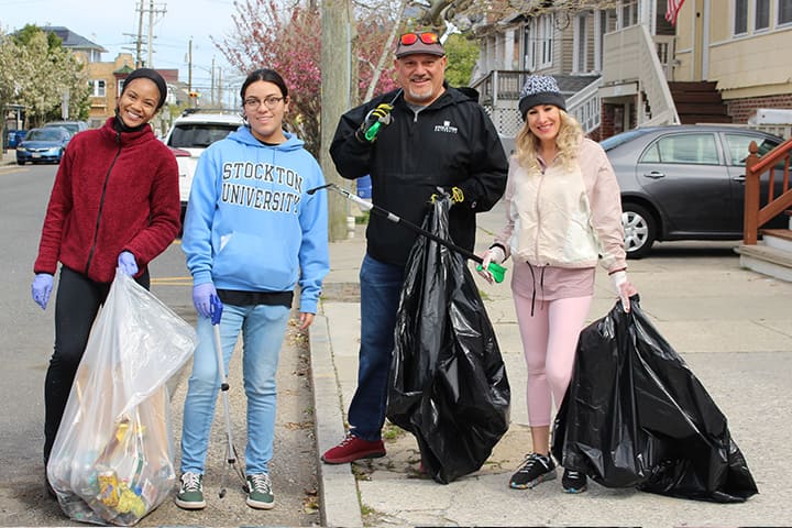 Four volunteers with trash bags in Atlantic City