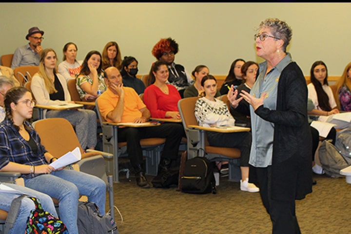 Sheryl Ochayon addresses a group of educators in a classroom