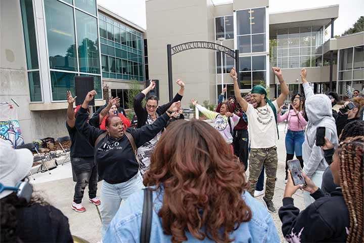 A large crowd of students dancing outside the Multicultural Center