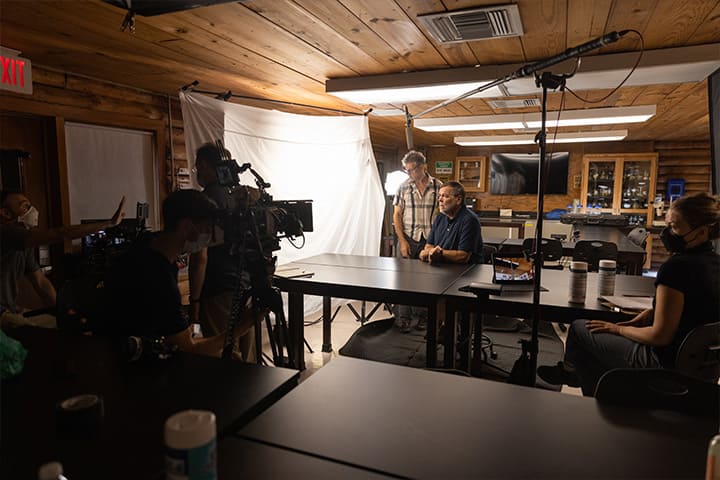 Faculty members with television cameras and lighting