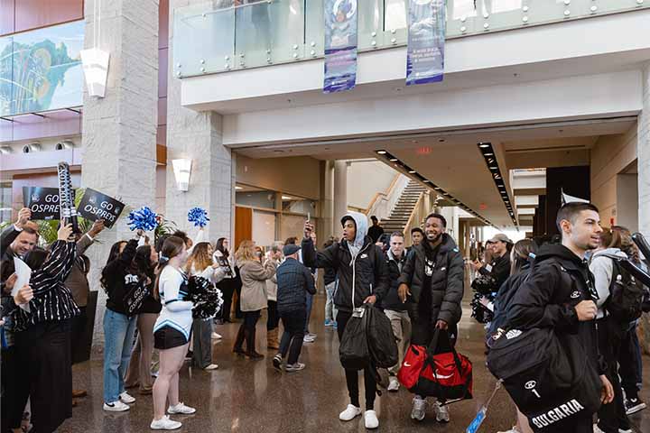 Basketball team members enjoying a send-off from the Stockton community in the Campus Center