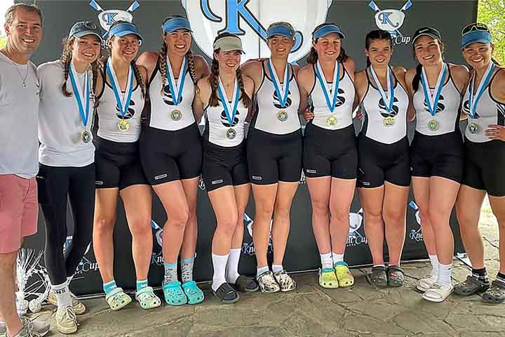 Stockton crew coach and team with their gold medals