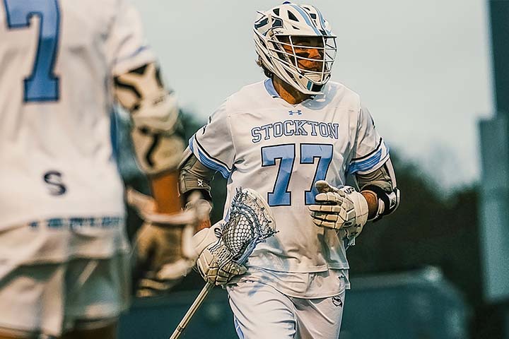 Luc Swedlund in his Stockton lacrosse uniform and helmet