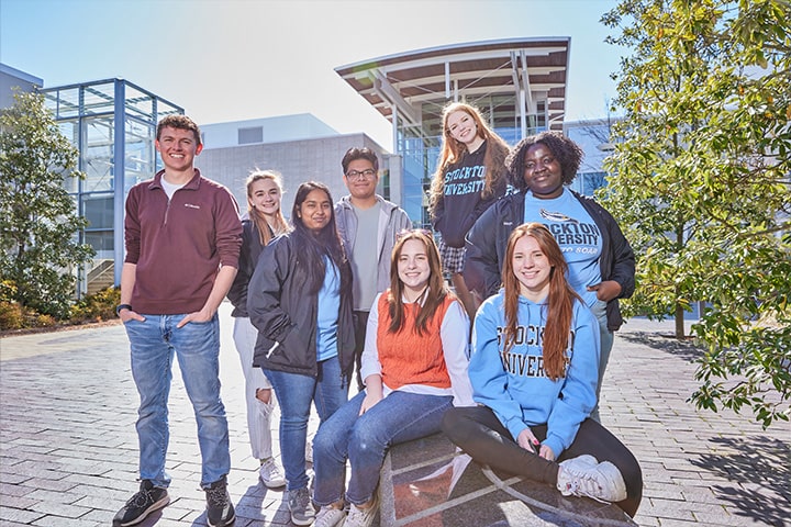 A diverse group of students outside the rear of the Campus Center