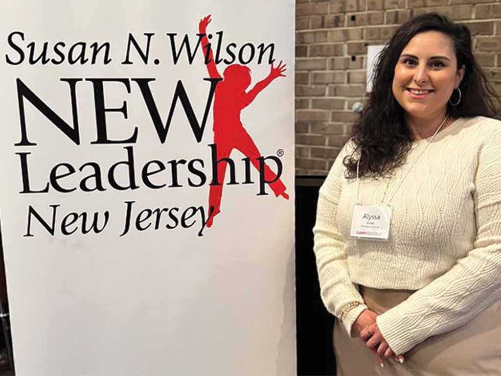 Alyssa Aviles next to a banner that read Susan N. Wilson NEW Leadership New Jersey