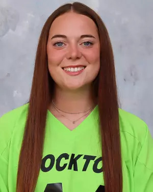 Erika Roura wearing a neon green field hockey jersey