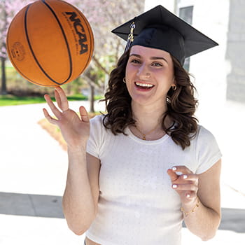 Emma Morrone spinning a basketball on her fingers and laughing