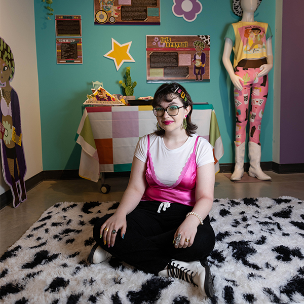 Giana Smith, sitting in front of her senior exhibition