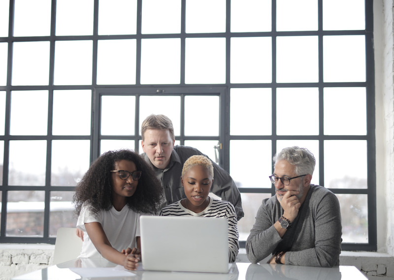 Group in front of a Laptop