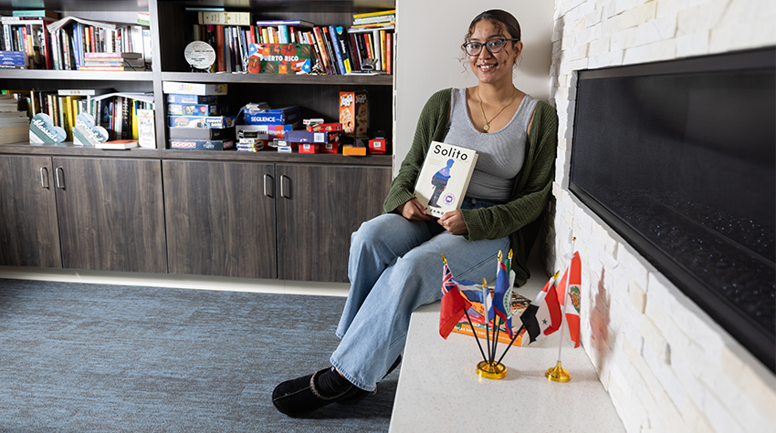 Taina in the Multicultural Center, holding "Solito"
