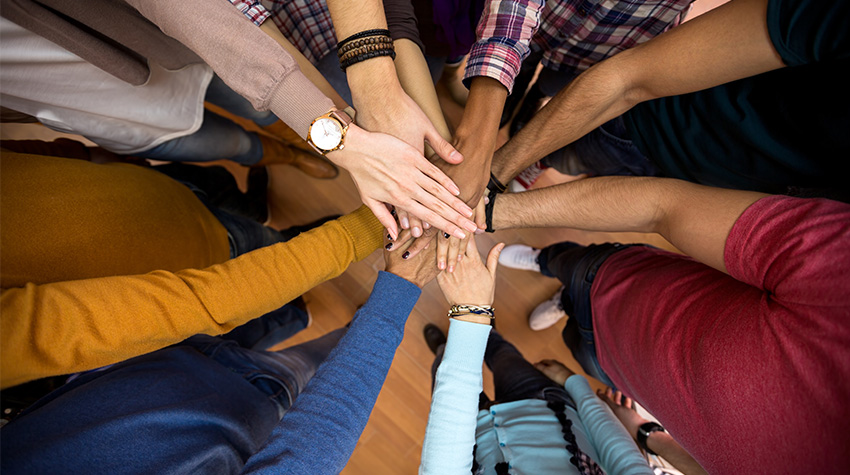 Hands gathered in a "go team!" sort of way