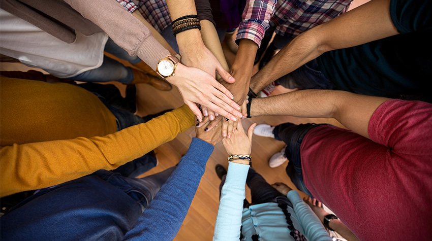 Hands gathered in the middle in a "go team" kind of way