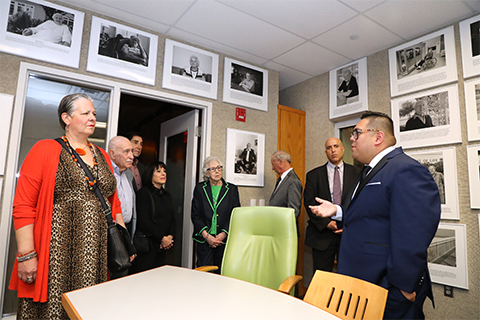 At right, Irvin Moreno-Rodriguez, the interim executive director of the Sara and Sam Schoffer Holocaust Resource Center at Stockton University, gives a group a tour of the center. At left, Mickey Ronan-Grosshtern, Leo Ullman, Henry and Barbara Roth, Maud Dahme, Mike Kleidermacher and Cary Booker.