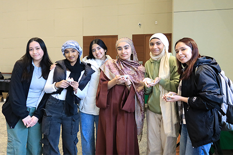 Students holding pottery they made during first ever Islamic Art Fair