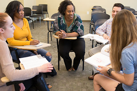 Donnetrice Allison surrounded by students in a classroom