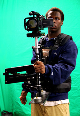 Student holding a video camera with stabilizer