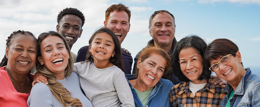 A group of people from age 3 to 70 smiling 