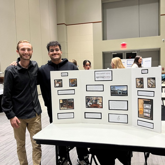 Picture of male students displaying project