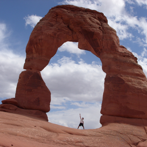 man under rock arch