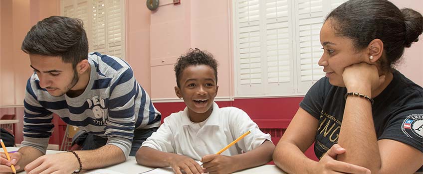 A young student gets help with his homework