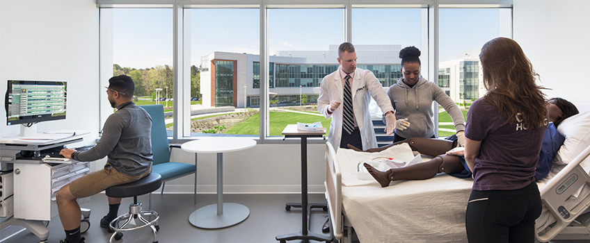 students practicing on mannequin