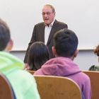 Photo of Marvin Raab speaking with students 