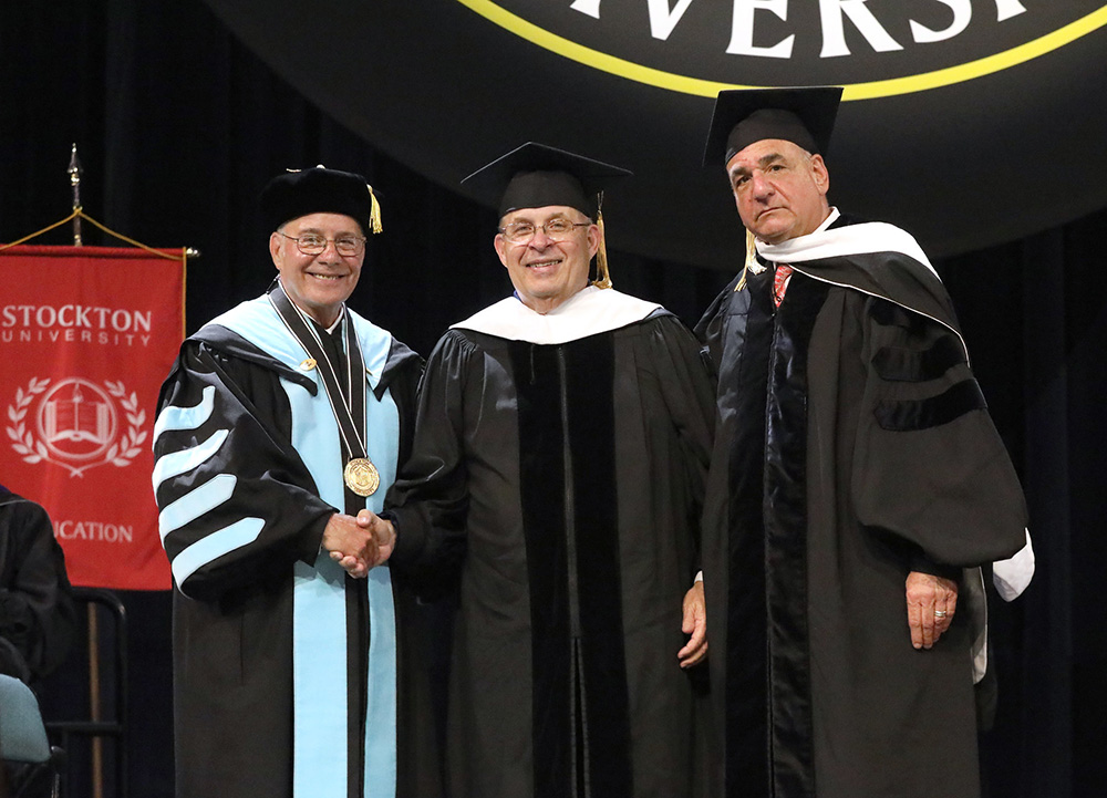 Retired Judge Julio Mendez receives an honorary Doctor of Public Service degree at Stockton University’s Commencement