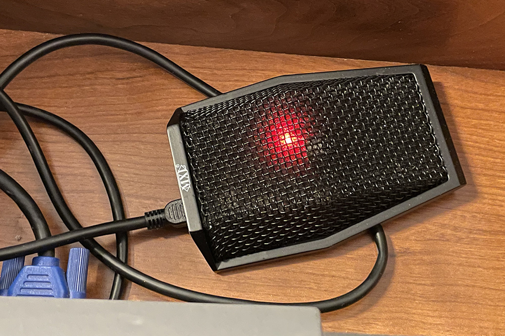 A photograph of a classroom microphone, located in the podium drawer.
