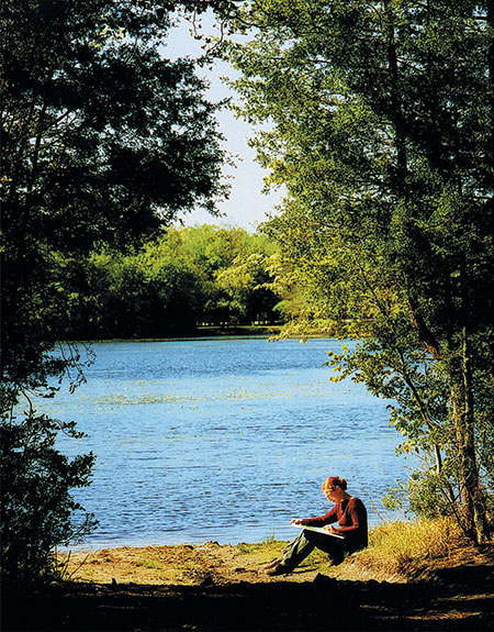 Student sketching by Lake Fred
