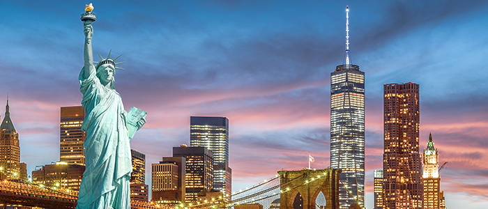 Collage of Statue of Liberty and NY Skyline at dusk