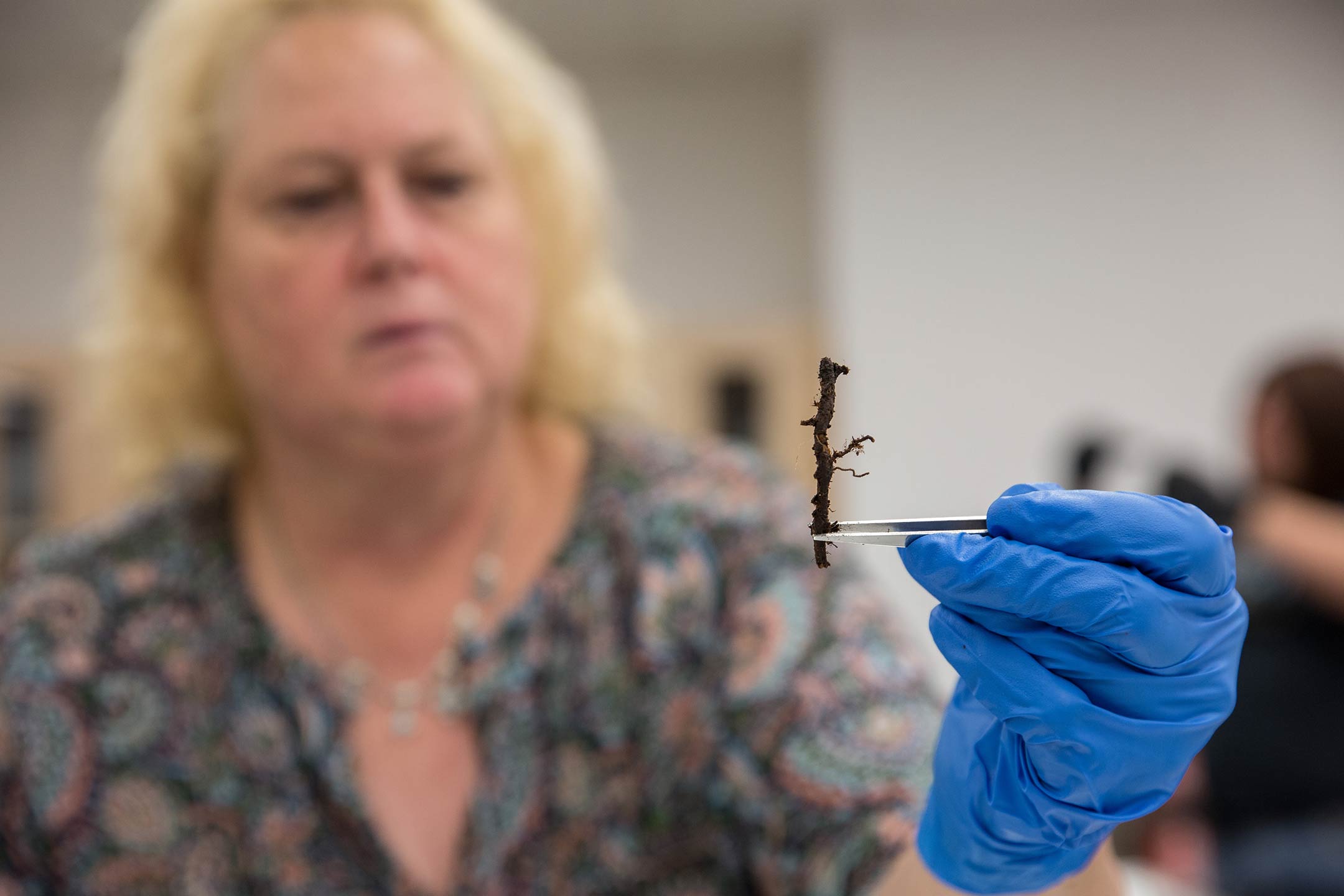 woman holding piece of vegetation