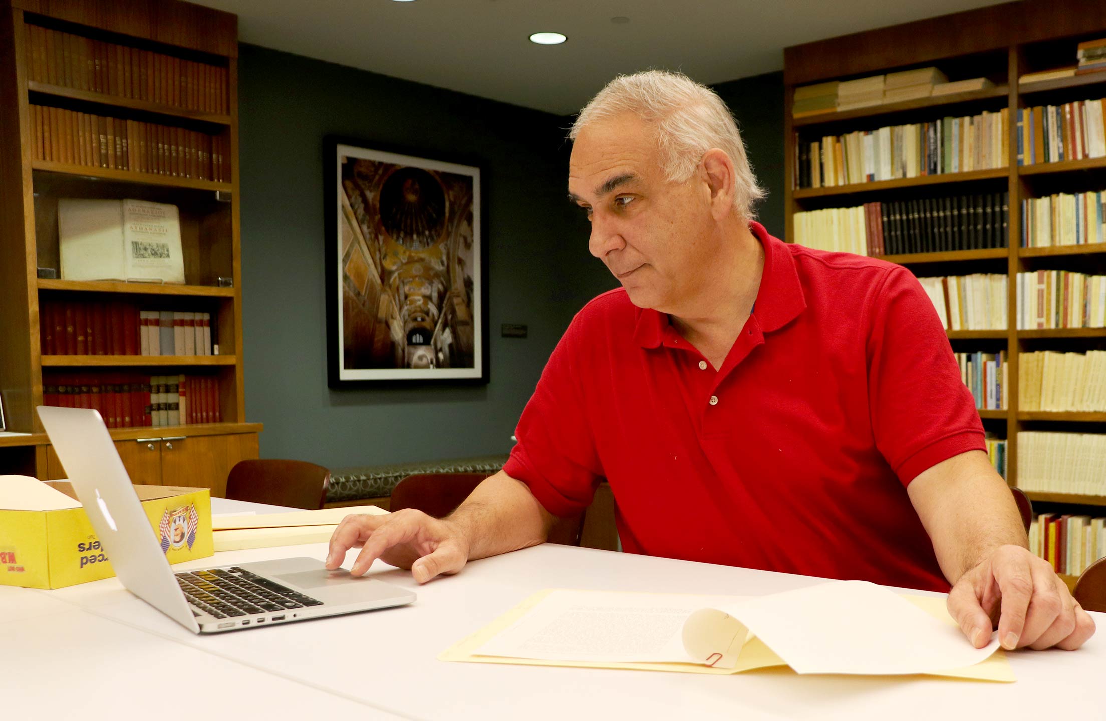 William Samonides translates the papers of Professor Demetrios Constantelos in the Constantelos Reading Room at Stockton University.
