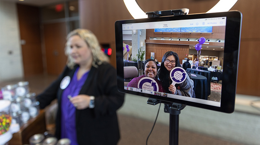Tierra Houston and Van Nhi Ho of the WGSC posing at the Sherwin-Williams table's selfie station.