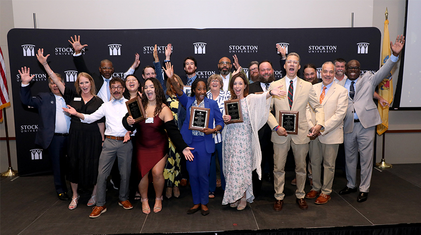 Awards recipients from this year and last gather for a photo.