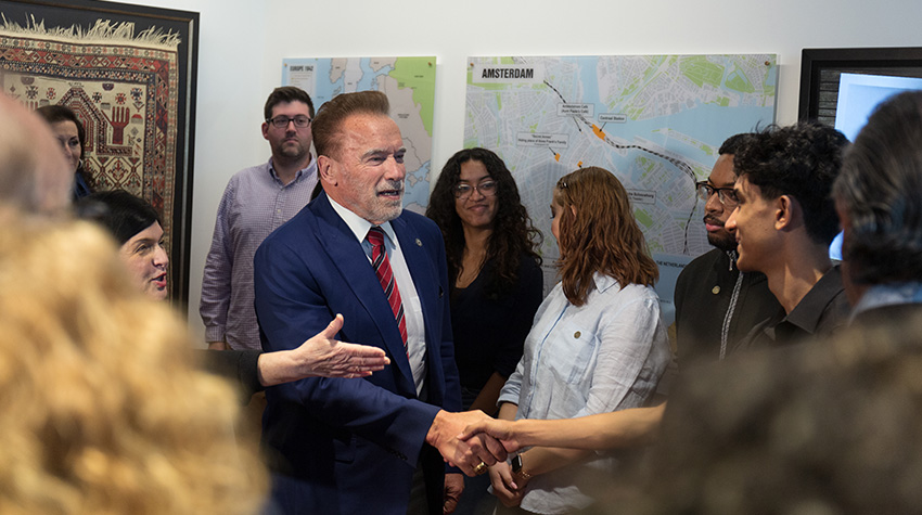 Arnold talking with students