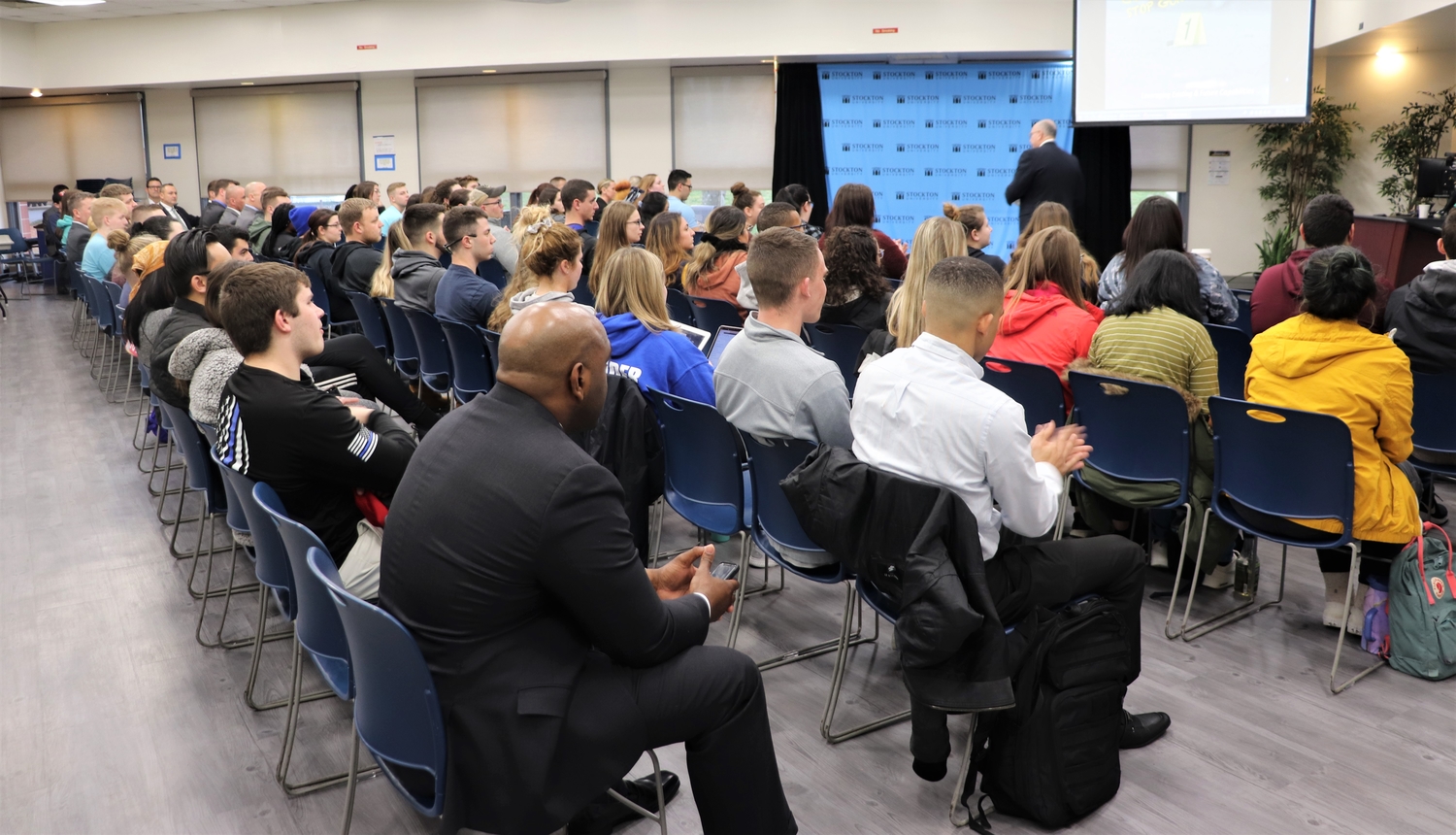 Students, faculty, staff, community and area law enforcement members wait for lecture to begin.