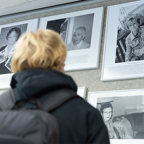 Student looking at portraits of Holocaust survivors