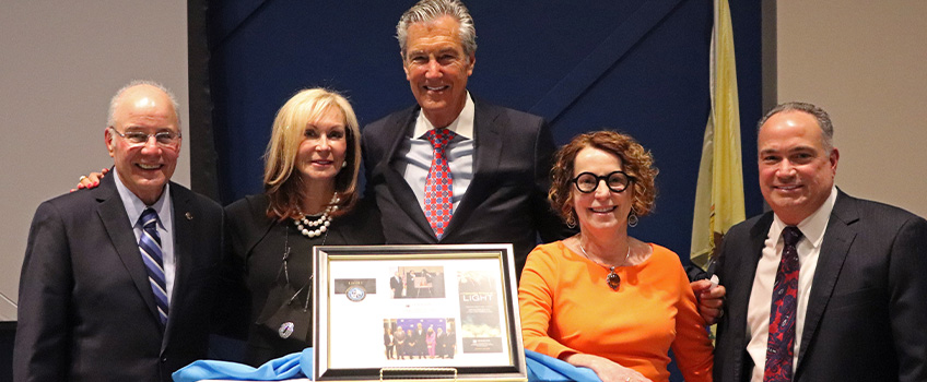 Stockton University President Harvey Kesselman, Liane Levenson, Lloyd D. Levenson, LIGHT Faculty Director Jane Bokunewicz and LIGHT Chairperson Mark Giannantonio surround the plaque presented to Lloyd Levenson for his significant contributions to Stockton University and the community.